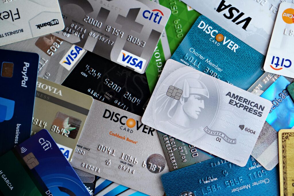 A flat lay of assorted credit and debit cards from various banks. Ideal for finance and banking concepts. Credit Card Debt Repayment