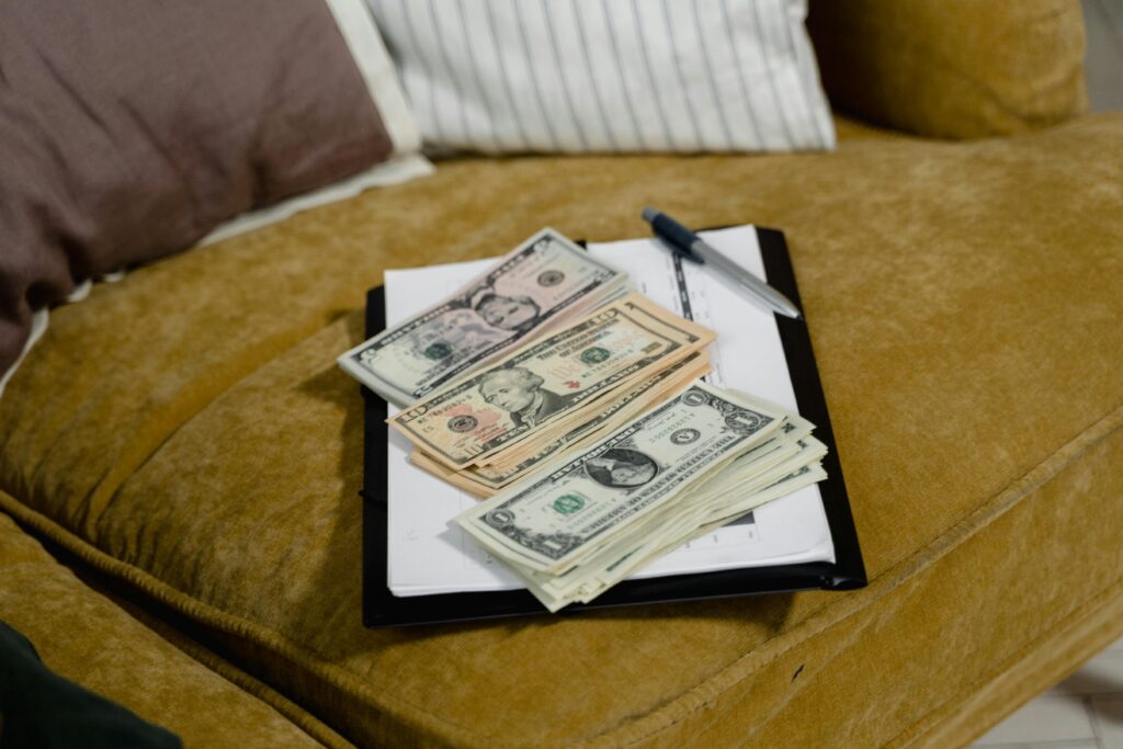 Close-up of US dollar banknotes on a sofa, symbolizing finance and wealth. Envelope Budgeting Made Easy