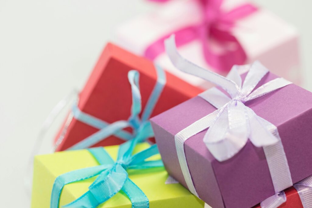 Close-up of vibrant gift boxes with ribbons, perfect for festive occasions. Budget Christmas Gifts