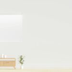 Bright minimalist room featuring an armchair, wooden dresser, and greenery.