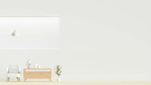 Bright minimalist room featuring an armchair, wooden dresser, and greenery.